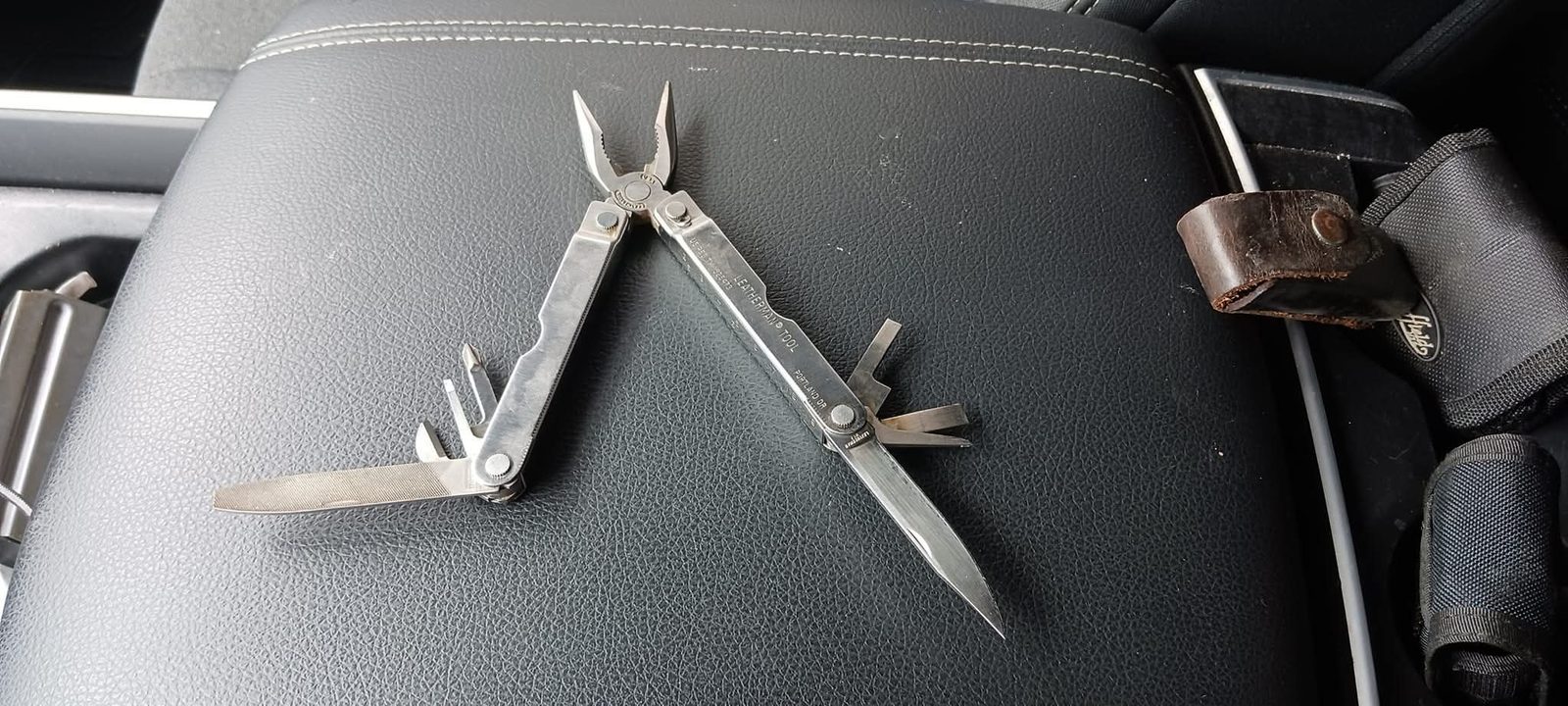 Original Leatherman Tool opened showing pliers, knife, and screwdrivers