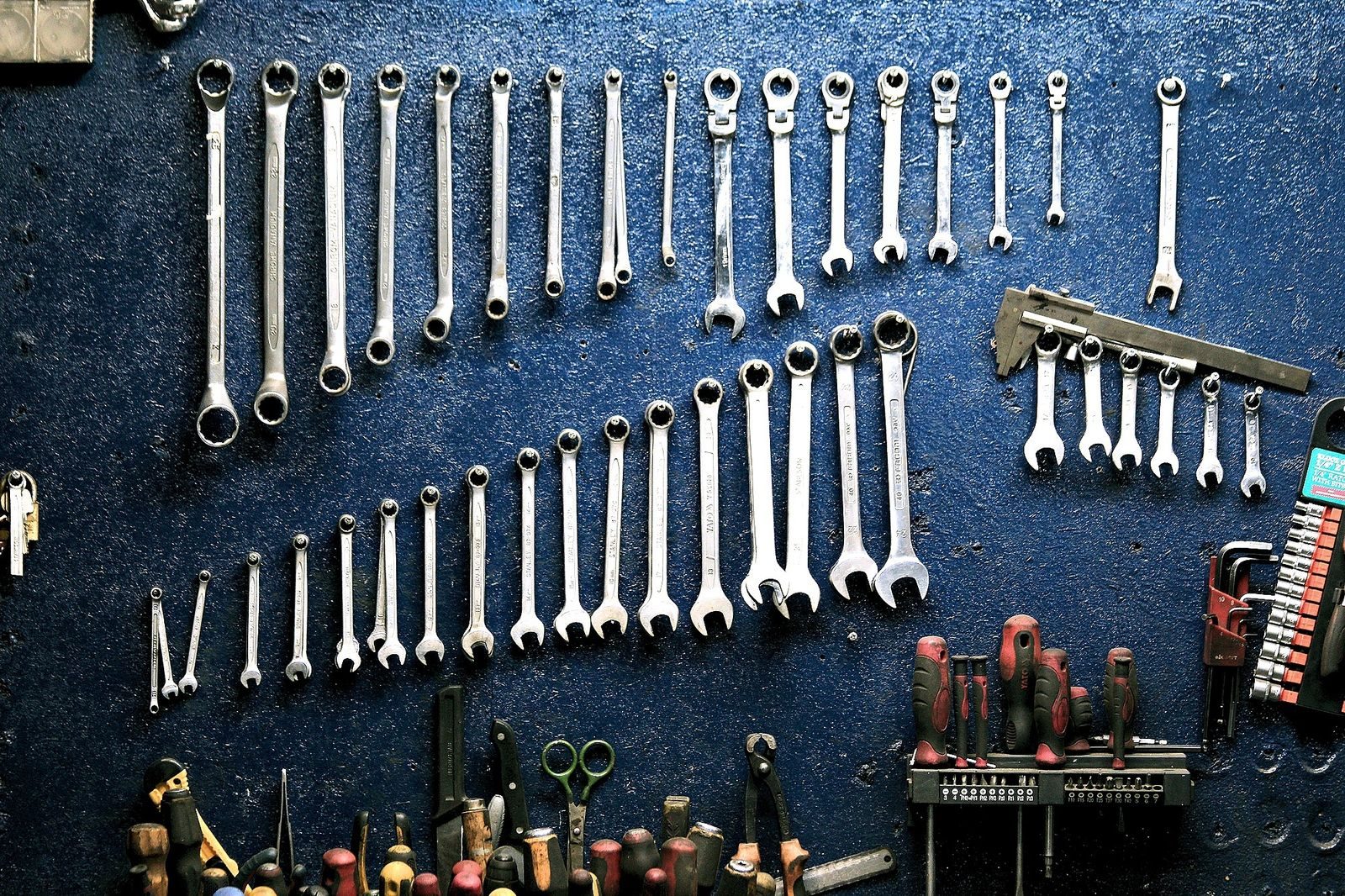 Assorted wrenches hanging neatly on a workshop wall